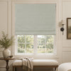 Alder linen look blackout Roman blind in light gray on a white window frame
